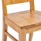 Switch A close-up of the Oxley Wooden Side Chair highlights its solid oak build and light finish, focusing on the seat, legs, and lower backrest. 2 image