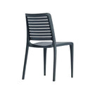 Switch The Lisbon Outdoor Stacking Side Chair in dark gray is made of weather-resistant polypropylene, with a slatted backrest and four straight legs, shown from a rear three-quarter view against a plain white background. 2 image