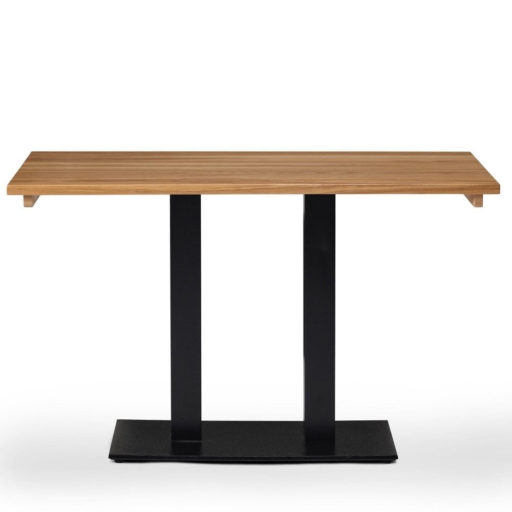 The Serranto Oak Stain Solid Ash Restaurant Table Top (25mm) features a modern rectangular design with a light ash finish and sleek black metal legs on a flat black base, ideal for stylish contemporary dining spaces. Set against a white background.