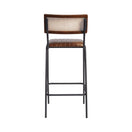 Switch The Savanna Bar Stool has a black metal frame, brown genuine leather seat, and a wooden backrest with natural cane detail, displayed from the back on a white background. 2 image