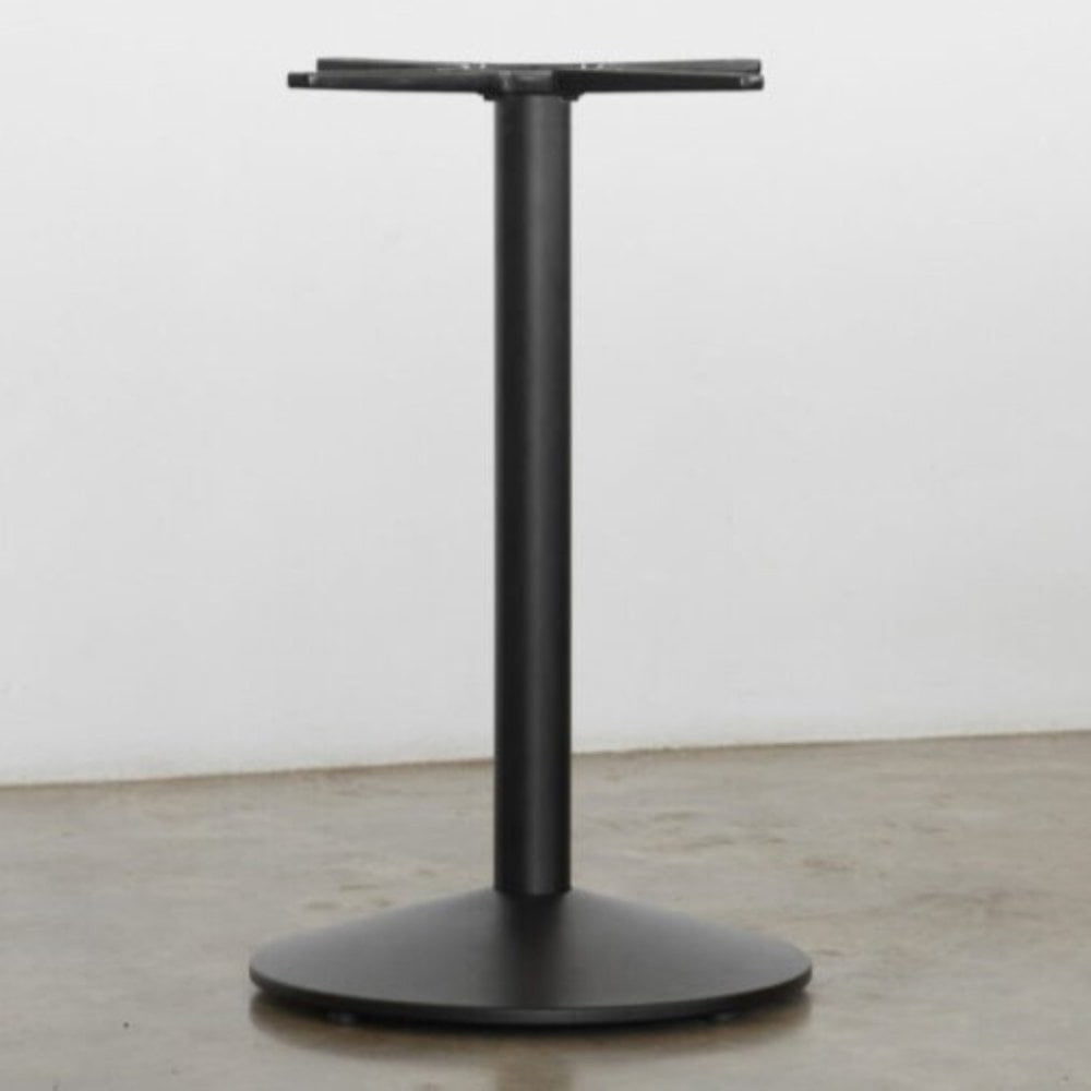 The Sol Black Round Self Levelling Table Base by NOROCK features a cone-shaped disc base with a vertical cylindrical column, shown here on a polished concrete floor against a white wall.