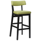 Switch The Nico Faux Leather Bar Stool - Black features a modern design with a light green padded faux leather seat and backrest, set on a sturdy black solid wood frame with four legs and a footrest. 3 image