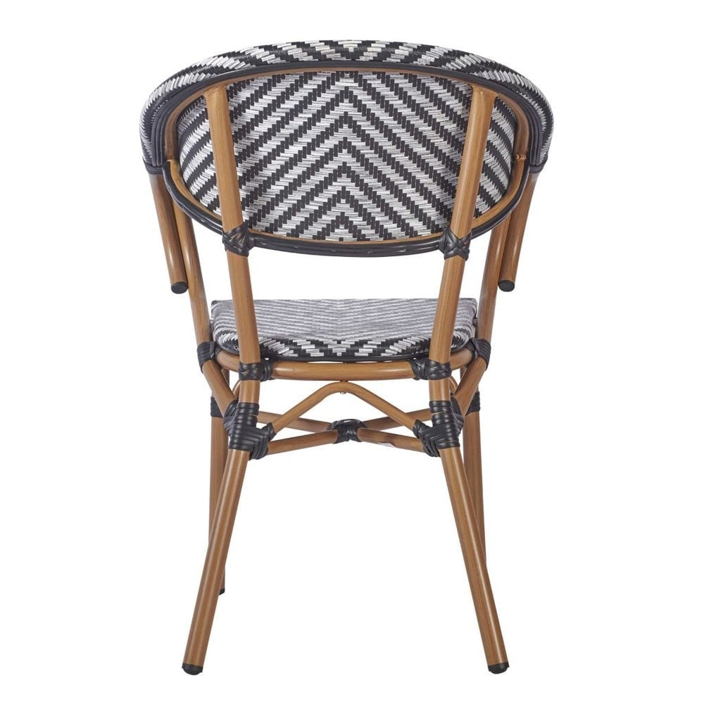 The Montpellier Bistro Outdoor Stacking Rattan Armchair features a light brown frame and black-and-white chevron woven design, offering a stylish waterproof seating solution for your pub garden or patio.