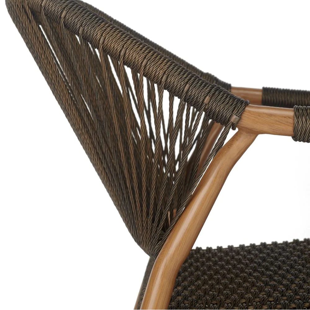 Close-up detail of a modern outdoor chair showing the woven backrest, light brown wooden frame, and dark brown textured seat against a white background.