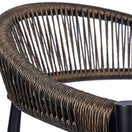 Switch Close-up of the Vienna Outdoor Stacking Rattan Armchair, a modern stackable chair with a curved backrest made of tightly woven brown synthetic rattan and sturdy black metal legs, shown against a white background. 3 image