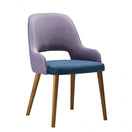 Switch The Joy Raw Side Chair Frame features a light purple upholstered backrest, blue cushioned seat, and four wooden legs—an ideal modern side chair for stylish spaces, shown against a plain white background. 2 image