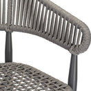 Switch Close-up of the Madrid Outdoor Bar Stool, featuring a gray woven polyester rope backrest and seat with vertical wrapped detailing, supported by black metal legs. 2 image