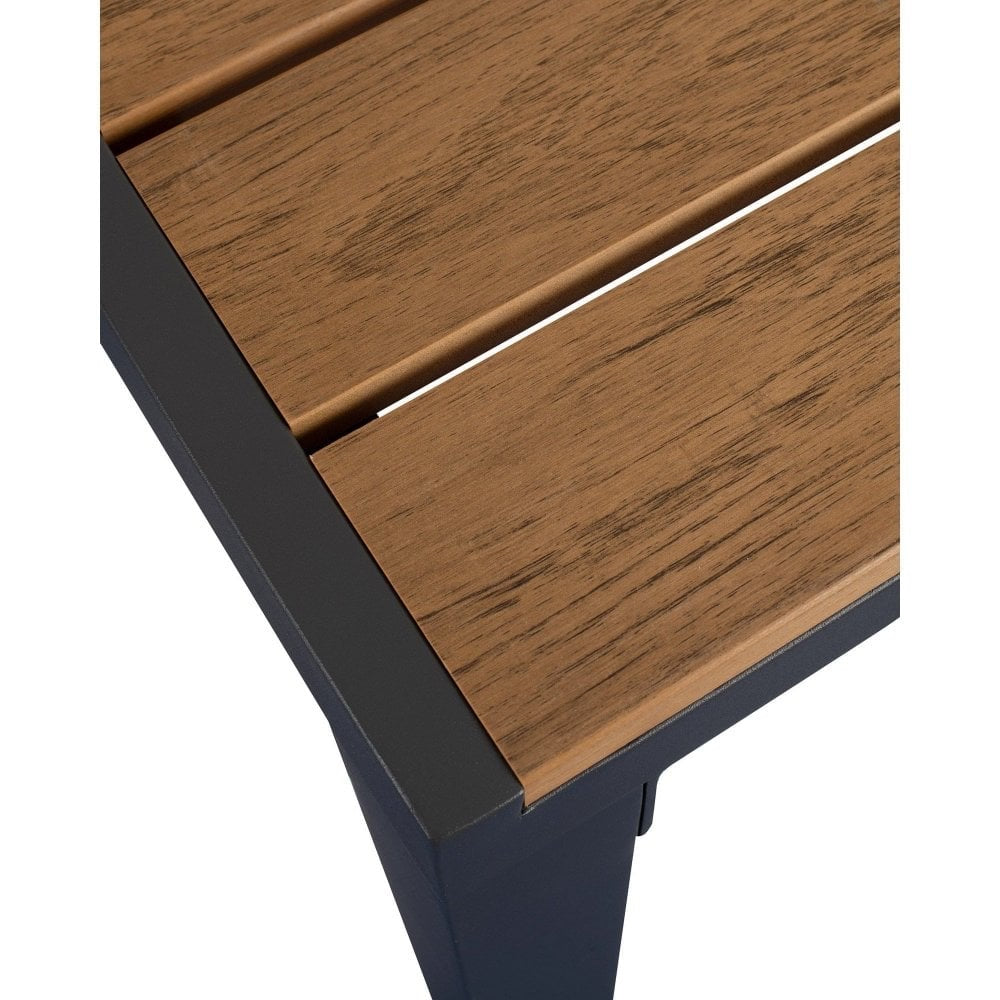 Close-up of the Riga Outdoor Solid Wood Bistro Table corner, featuring a slatted tabletop with a natural wood finish and a sturdy dark metal frame and legs.