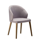Switch The Serene Raw Armchair Frame is a modern armchair featuring a curved, upholstered light gray backrest and seat, supported by four angled wooden legs. 2 image