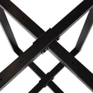 Switch Close-up of the Hyde Extra Large Black Round Table Base, featuring black steel beams crossing in an X shape for a modern criss-cross design, secured by visible screws and bolts. 3 image