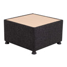 تبديل الصورة Square ottoman with a black fabric base, light wood top, and short black feet, photographed on a white background. This versatile piece complements reception area furniture and pairs seamlessly with the Glacier Table Module for a cohesive modern look. 1