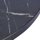 Switch A close-up of the Black Pietra Marble Laminate Restaurant Table Top - 25mm, featuring a round, dark gray surface with white marble-like veining and a smooth, slightly beveled edge for an elegant look. 3 image