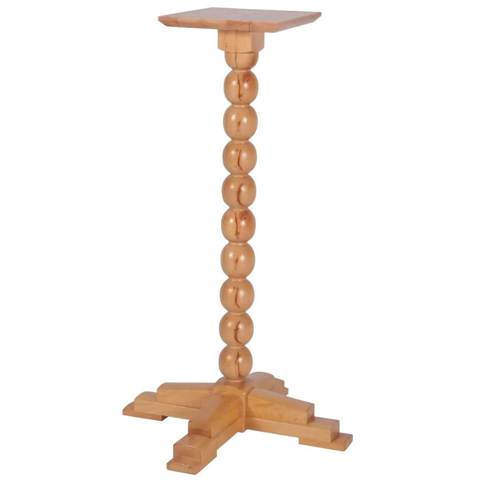 A light natural wood pedestal table with a square top, a vertical stem made of stacked round beads, and a four-leg cross base, shown on a plain white background.