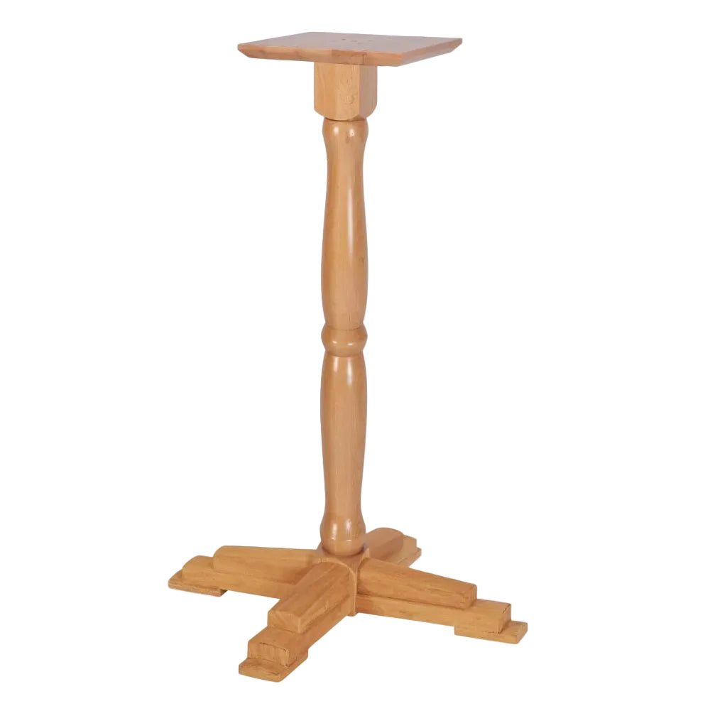 A light natural wood pedestal table with a square top, turned central post, and four-leg base, shown on a plain white background.